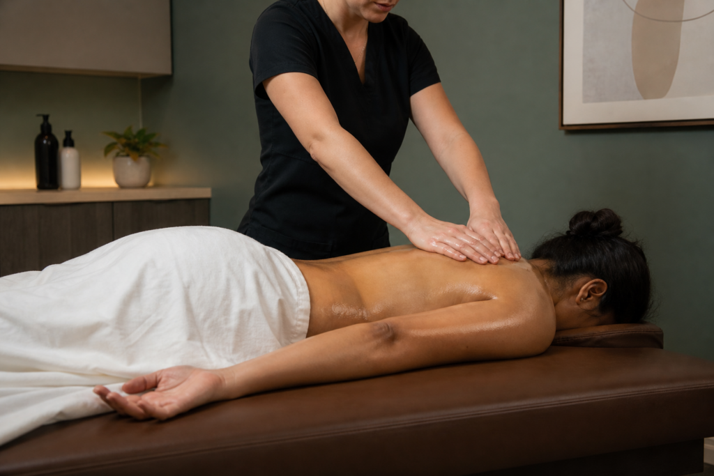 Abhyanga Ayurvedic warm herbal oil application during full-body massage at Li's Spa Redmond WA