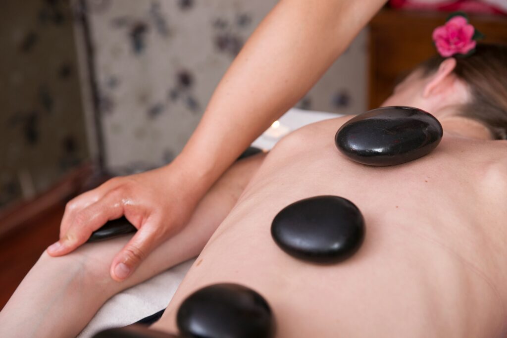 Hot stone massage on back from licensed therapist at Li's Spa Redmond