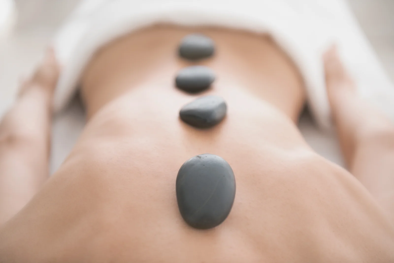 Basalt hot stones placed on spine at Li's Spa Redmond