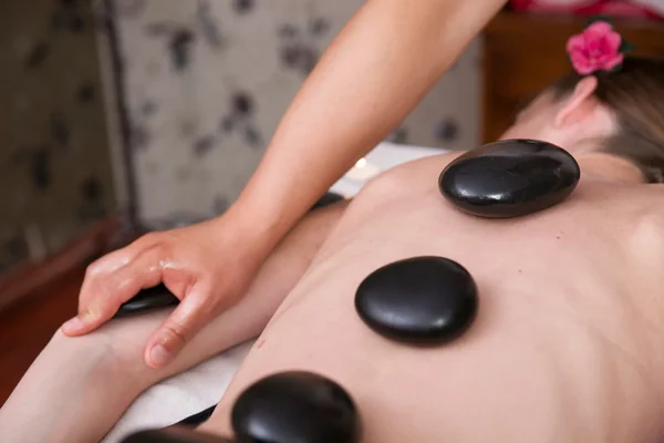 Hot stone massage on back from licensed therapist at Li's Spa Redmond